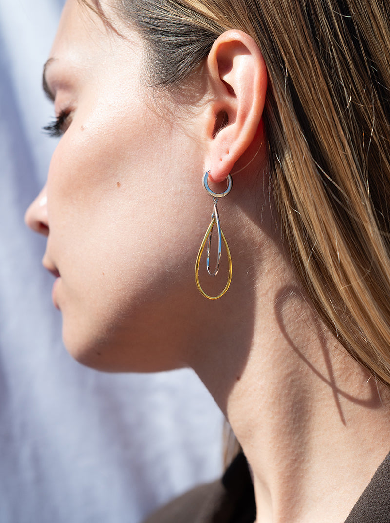 Long two-tone silver earrings with a teardrop design