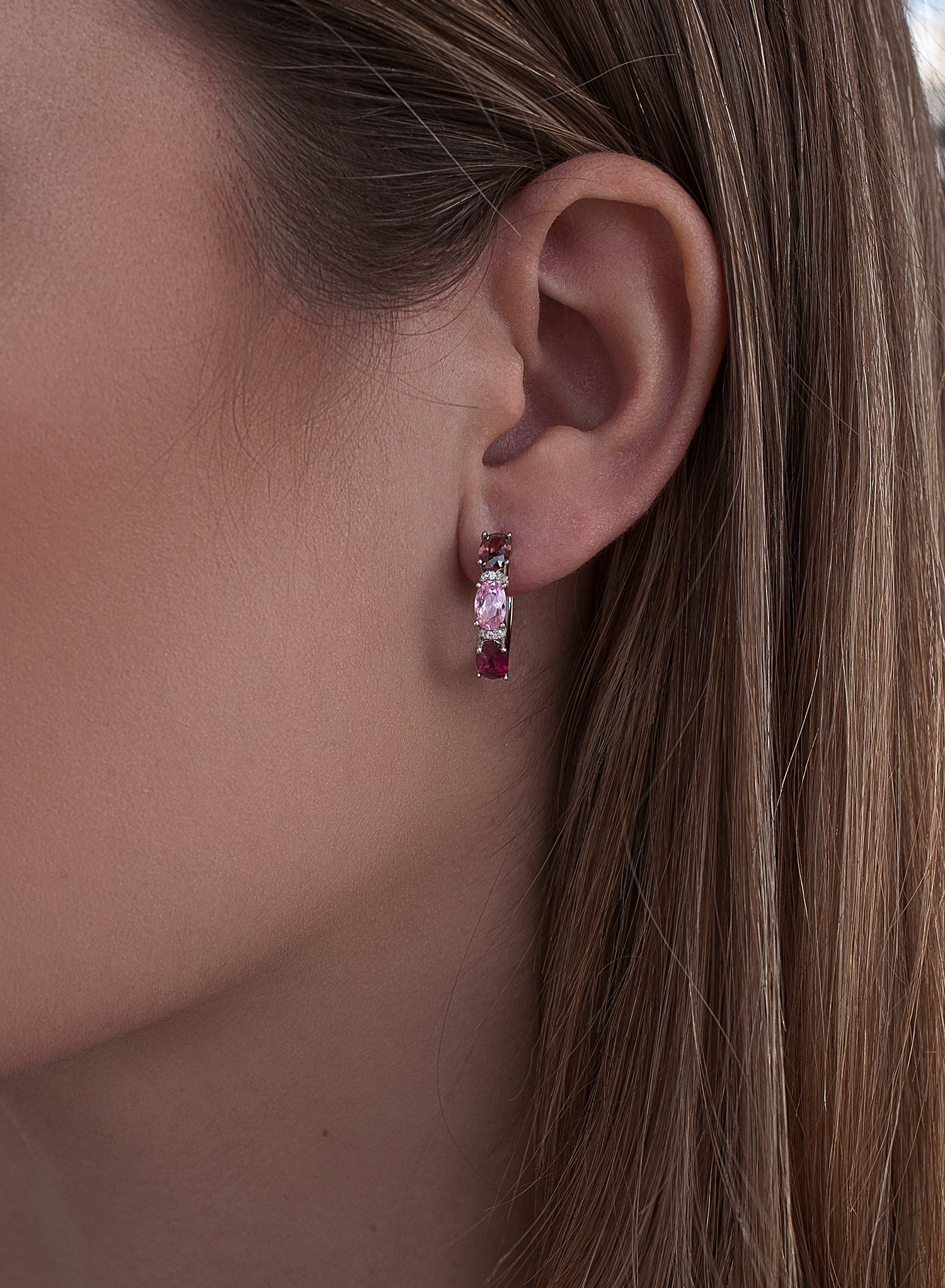 Small silver hoop earrings with a pink design