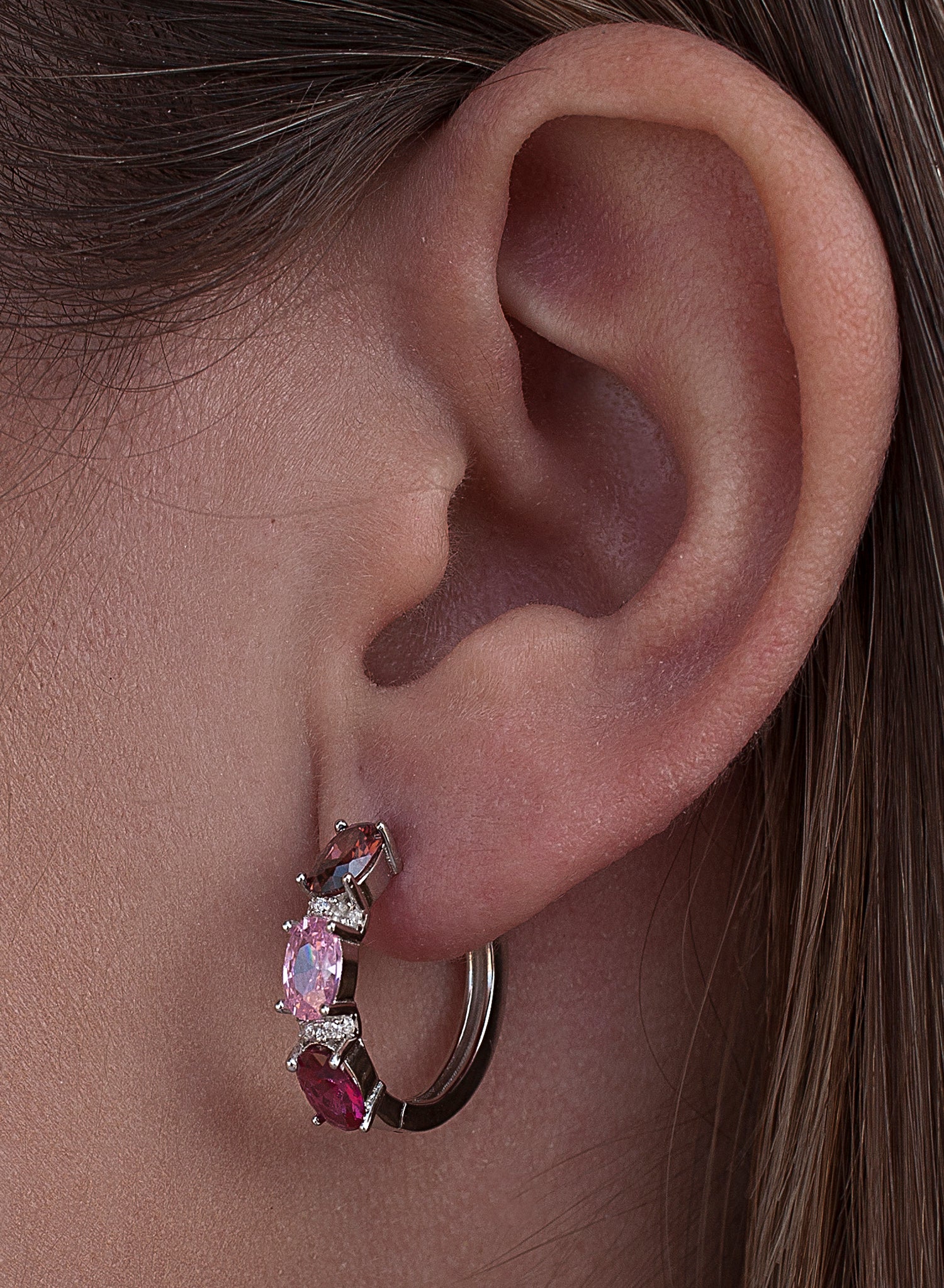 Small silver hoop earrings with a pink design