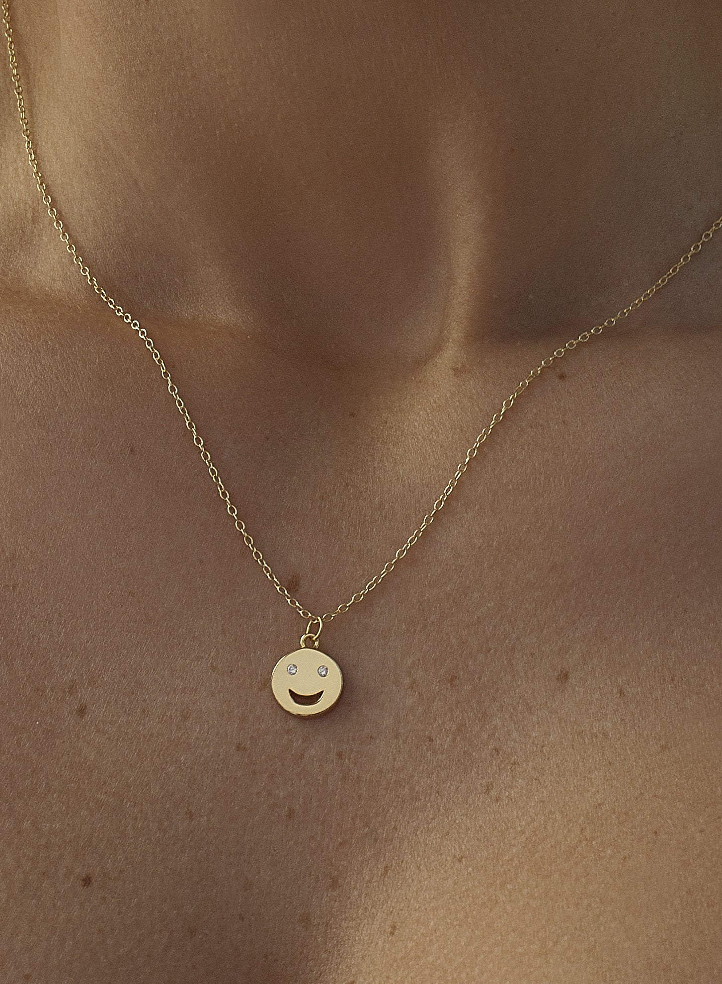 Petits pendentifs en argent simple représentant un visage souriant