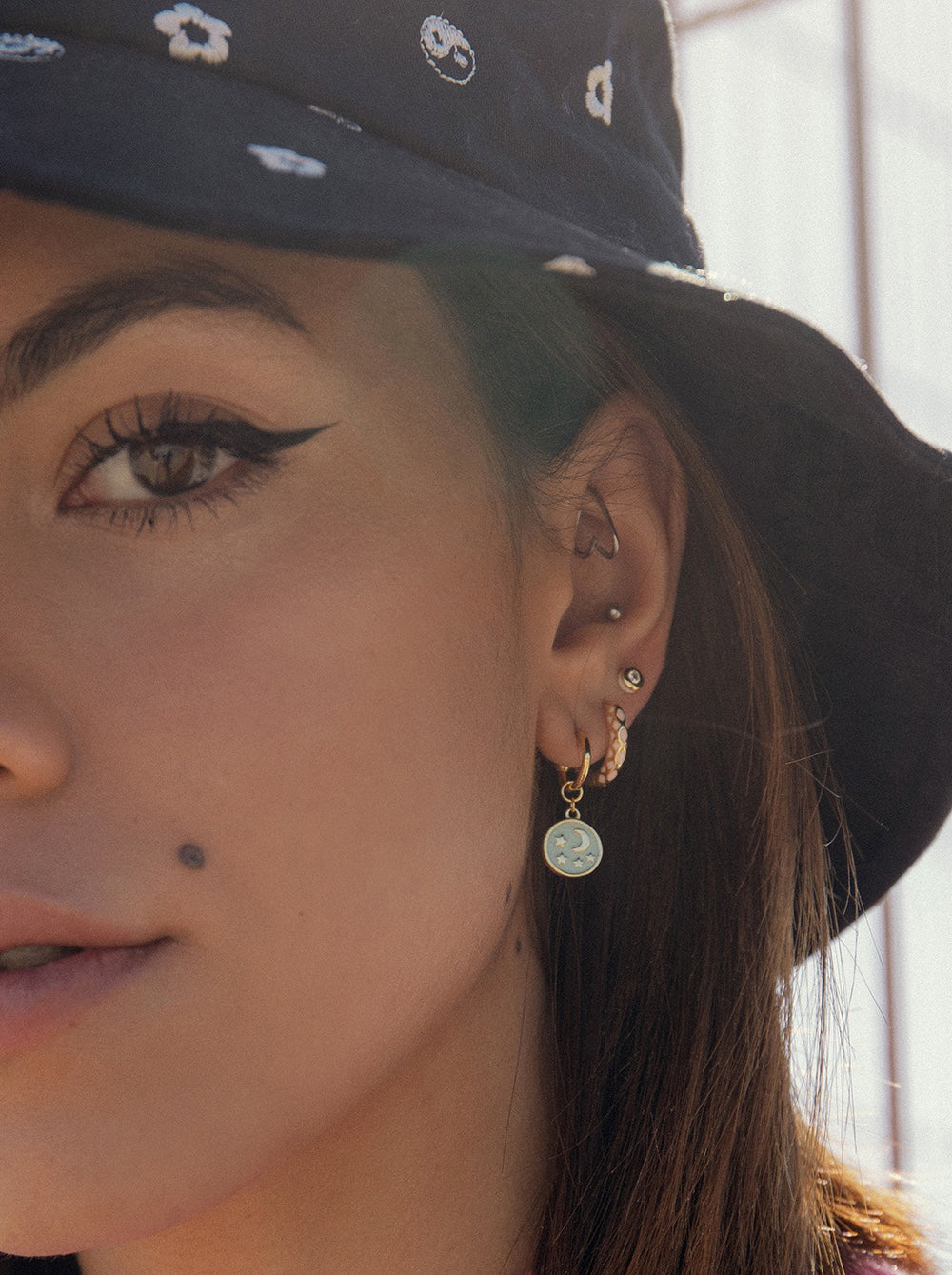 Hoop earrings with moon and star medallion design pendants