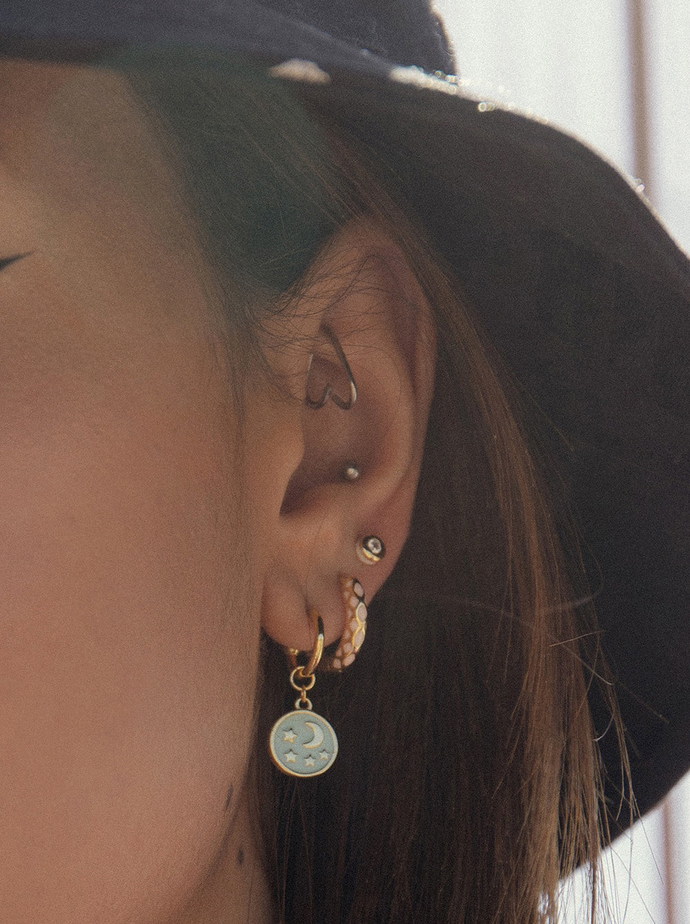 Hoop earrings with moon and star medallion design pendants