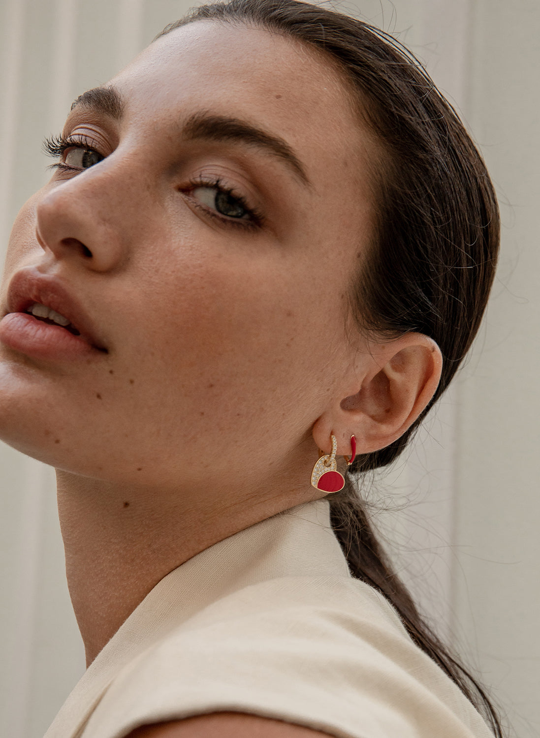 Earrings with red enamel heart design pendants