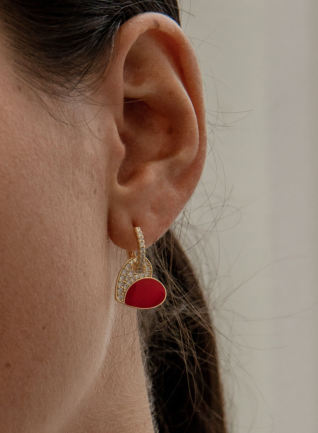 Earrings with red enamel heart design pendants