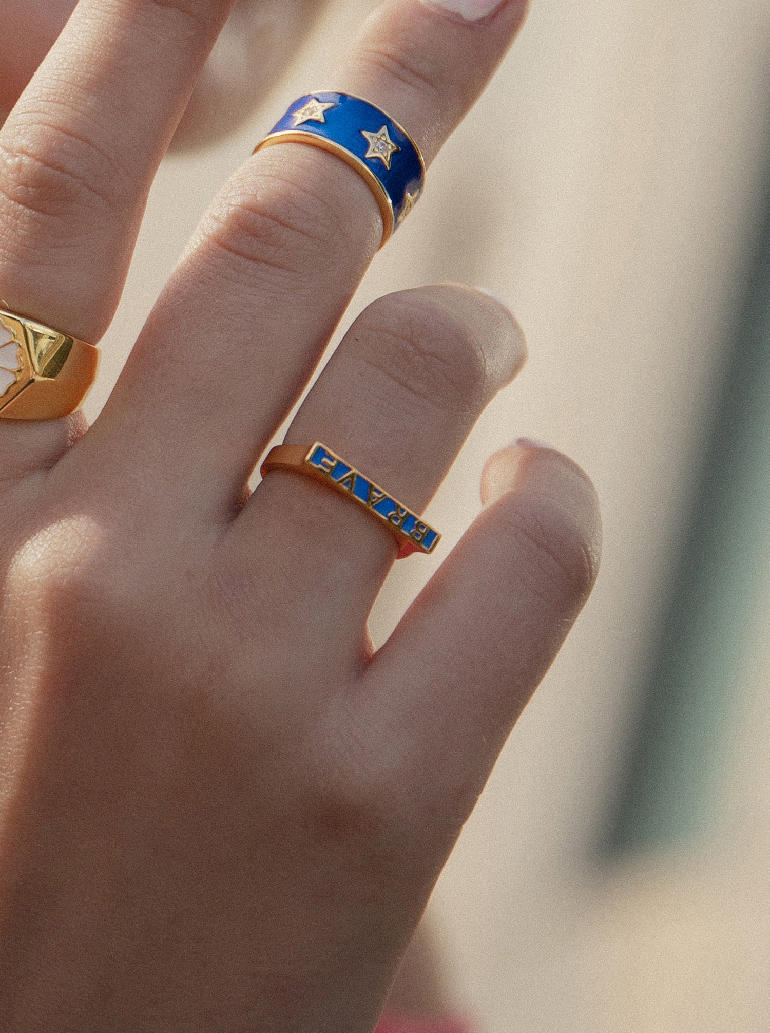 Thin silver rings with a "brave" design in enamel