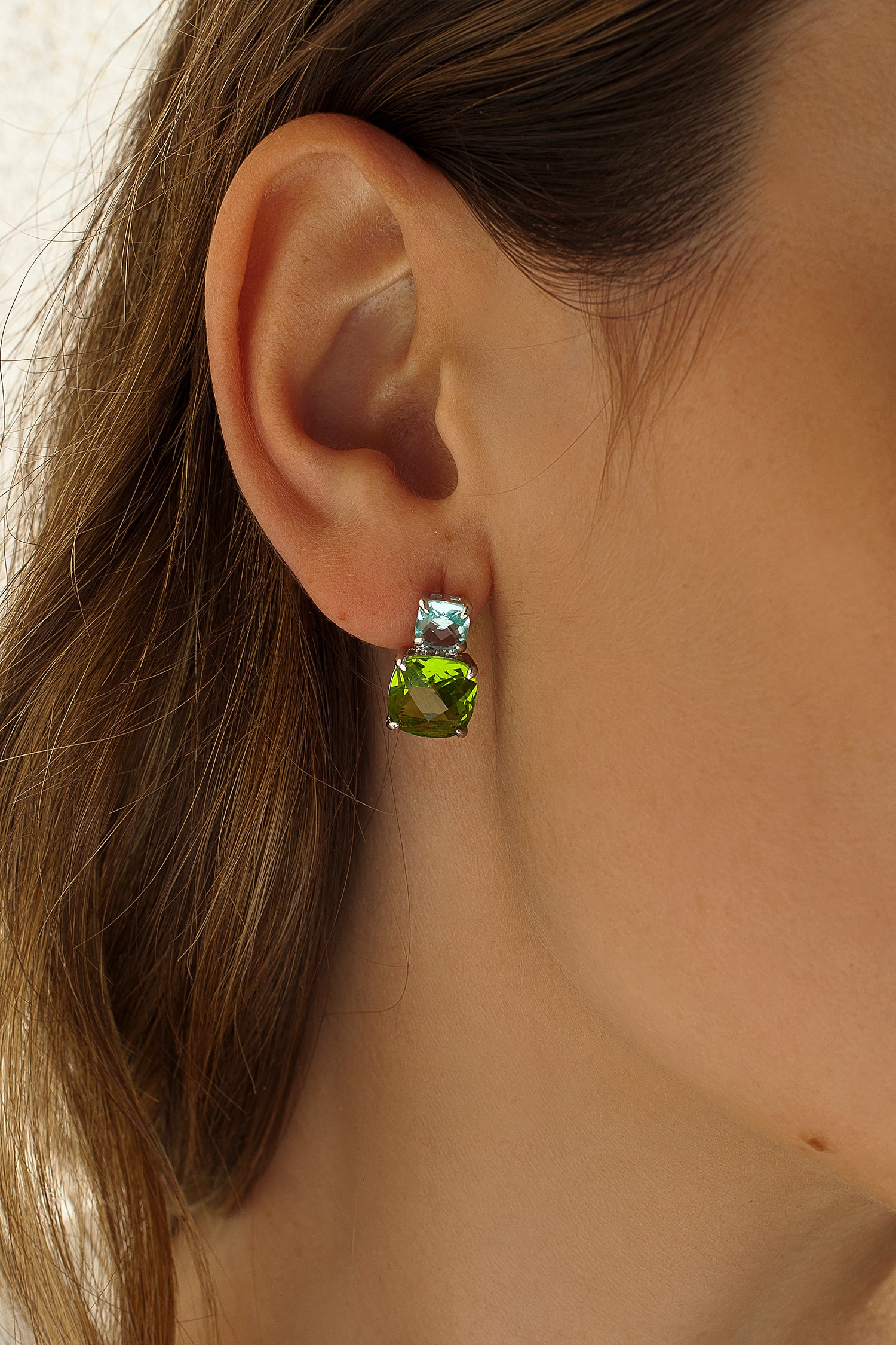 Colorful gemstone earrings with a two-tone gem design