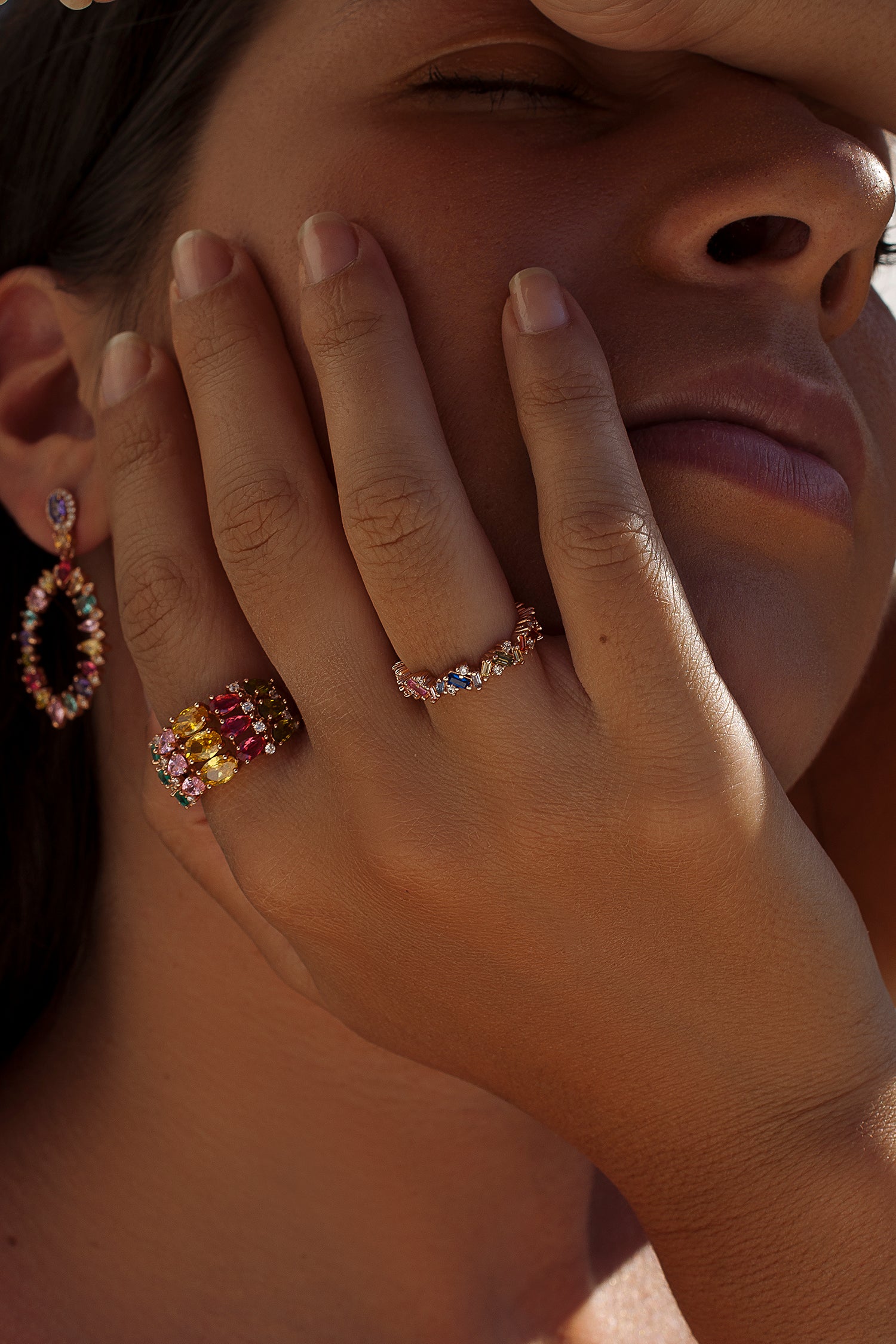 Rings with colored stones and a bow in cool tones
