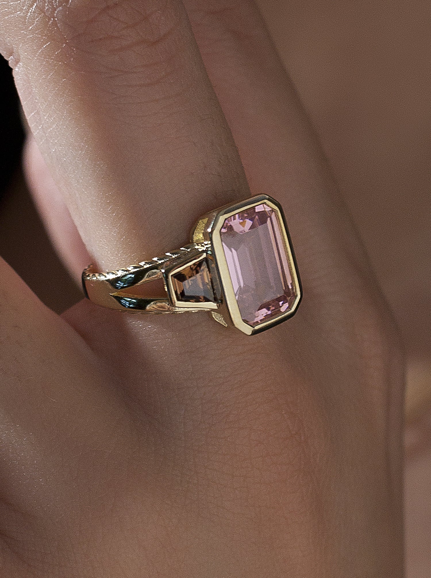 Rings with radiant cut stones in a pink tone