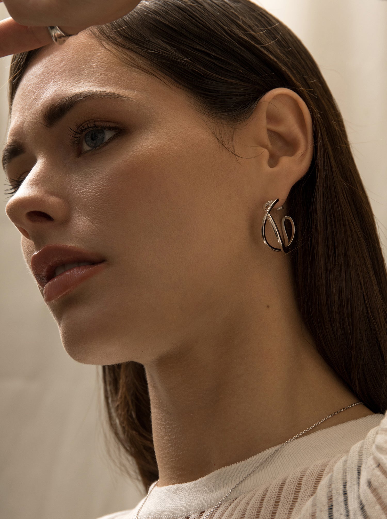 Original hoop earrings with a double intertwined channel design and smooth silver