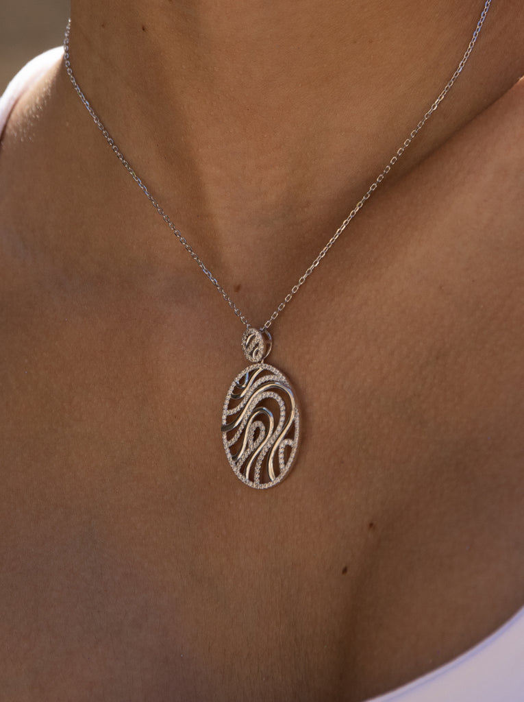 Colgante brillante diseño ovalado con detalles de circonitas