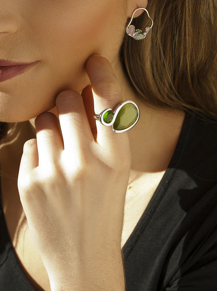 silver ring with green stones in a modern design