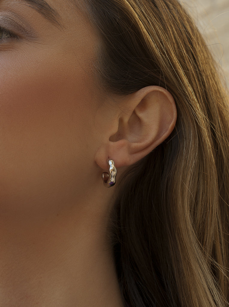Silver hoop earrings with irregular liquid design