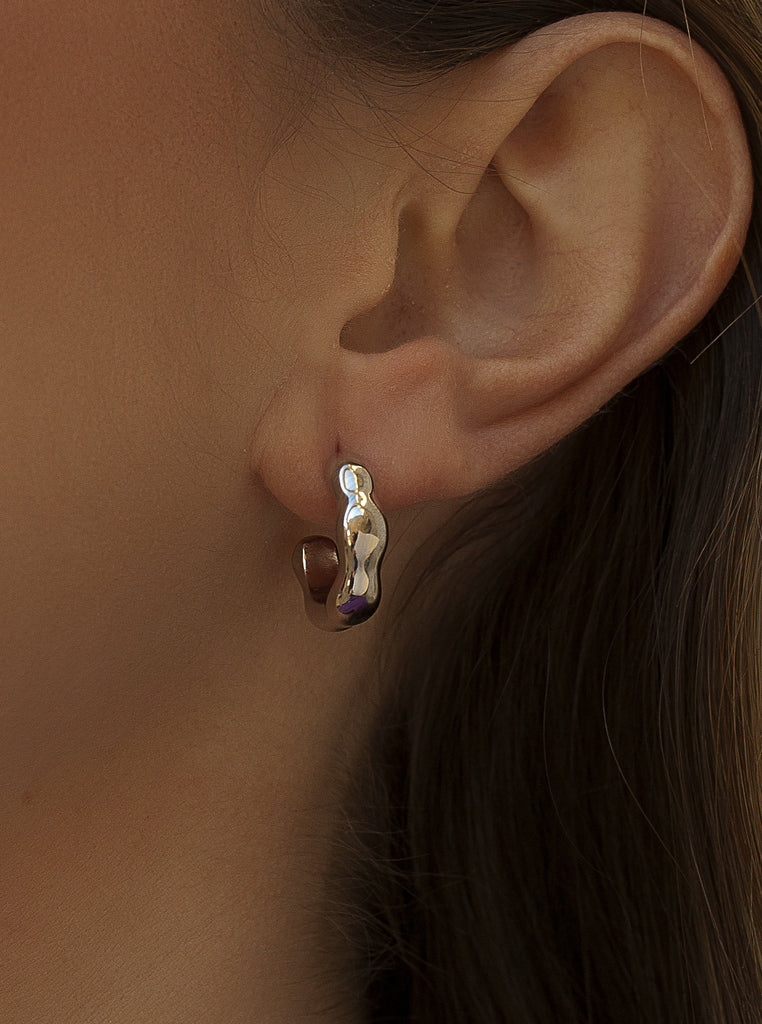 Silver hoop earrings with irregular liquid design