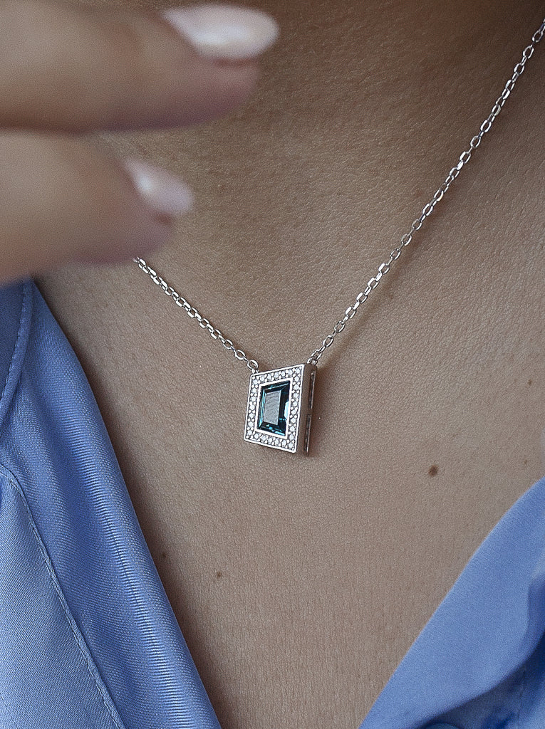 Silver necklace with blue cubic zirconia pendant and cubic zirconia stones