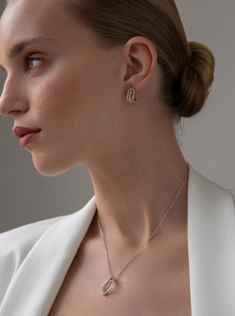 Two-tone silver hoop earrings with cubic zirconia cross design