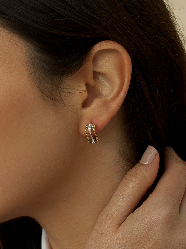 Two-tone silver hoop earrings with cubic zirconia cross design