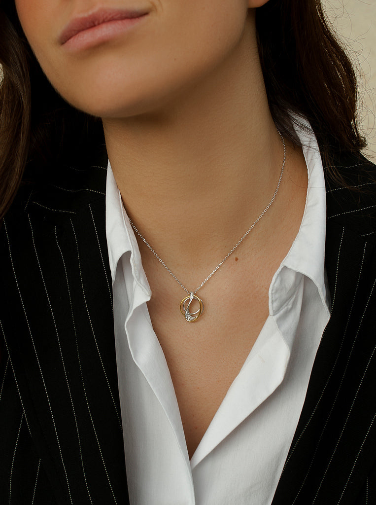 Two-tone silver necklace with intertwined cubic zirconia