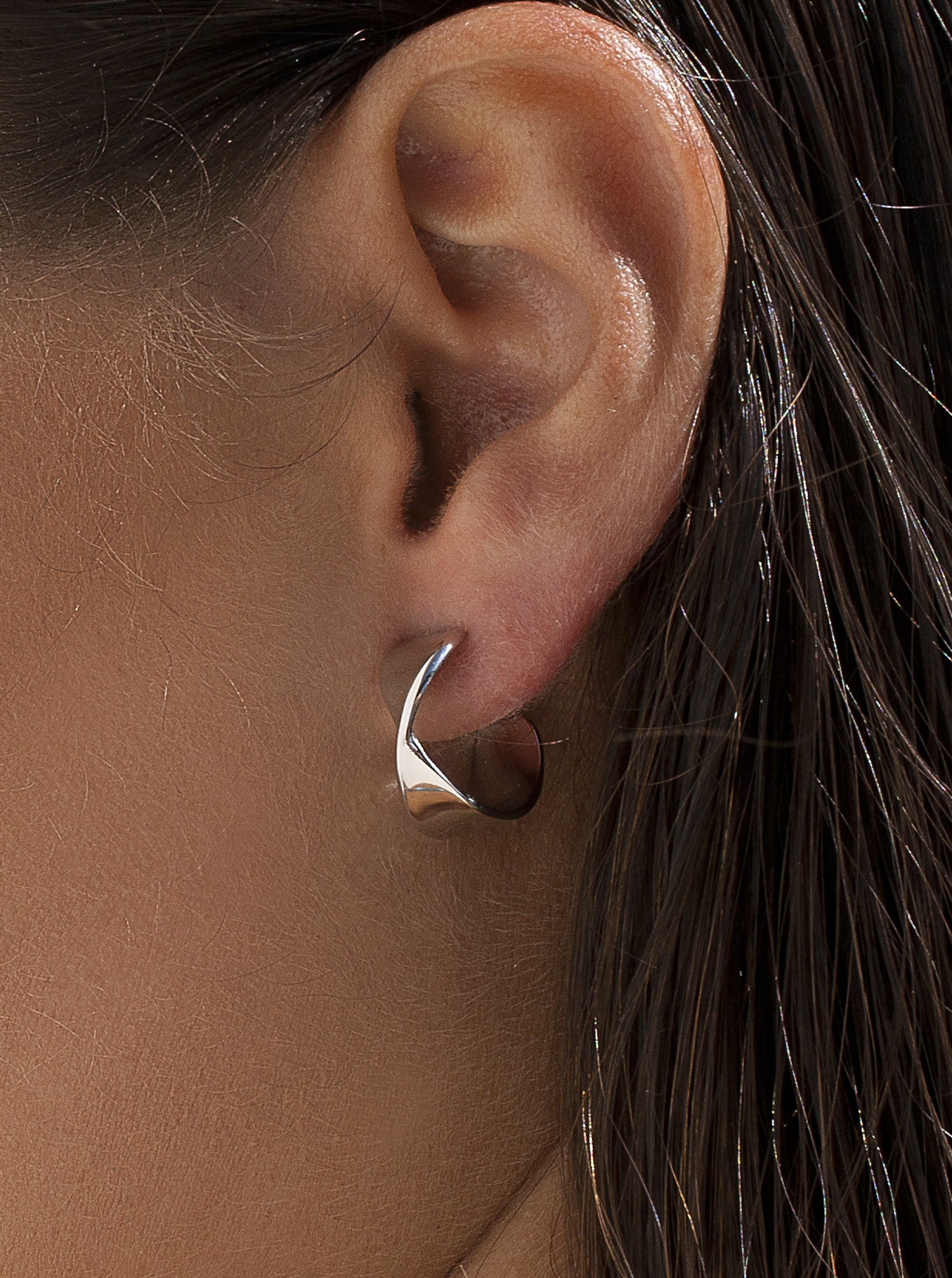 Silver earrings in a semi-open hoop