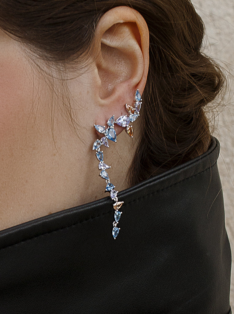 Long silver climber-style earrings with colorful stones