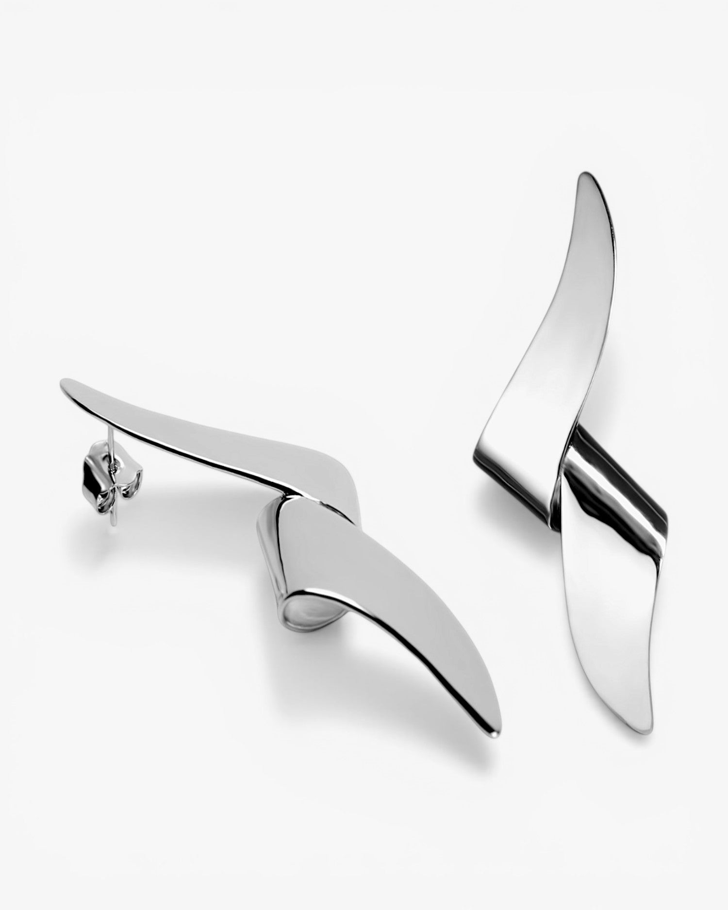 Long silver earrings with a tangled design