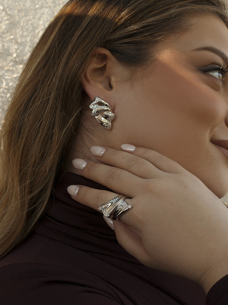 Sculptural silver earrings with cubic zirconia