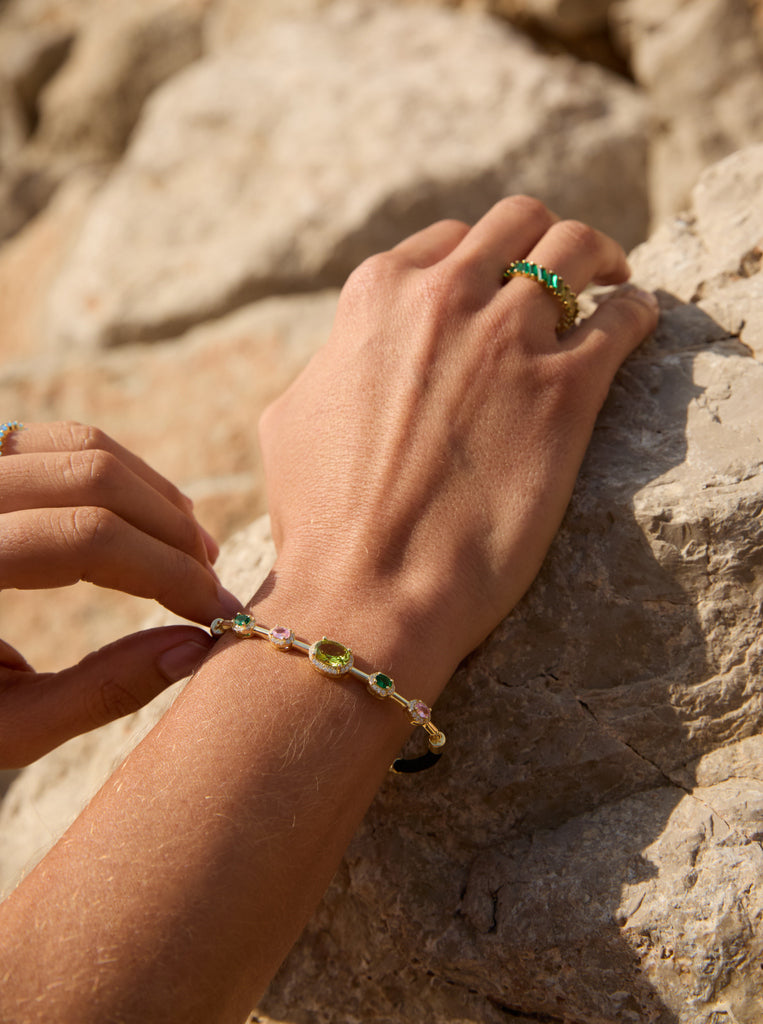 Silver bracelet with colored stones in shades of green and black cord