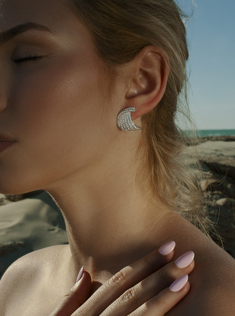 Silver earrings with curved cubic zirconia design