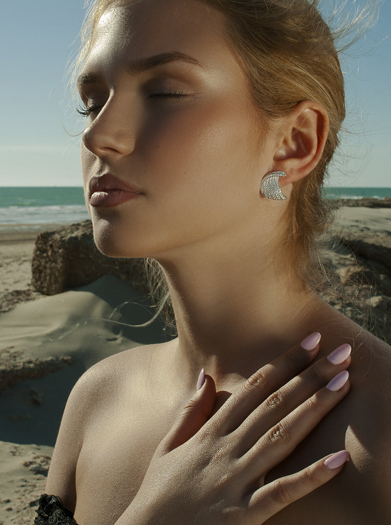 Silver earrings with curved cubic zirconia design
