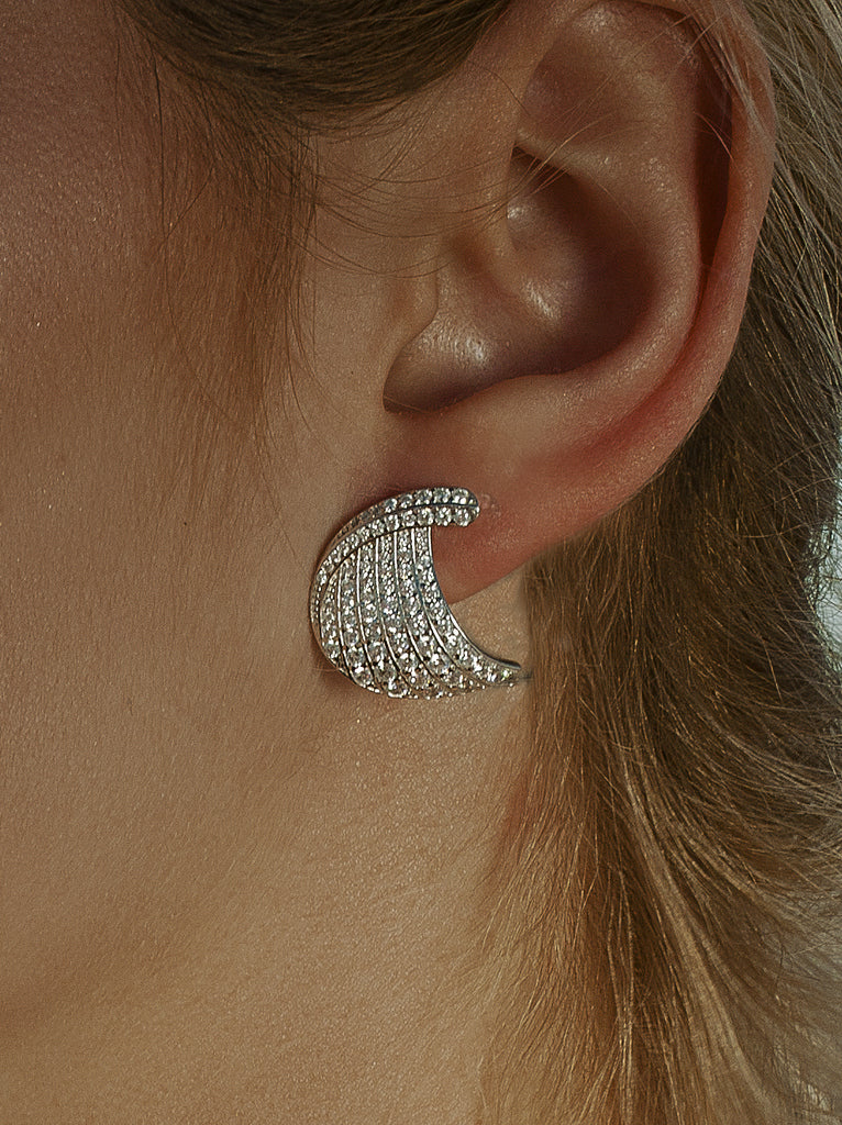 Silver earrings with curved cubic zirconia design