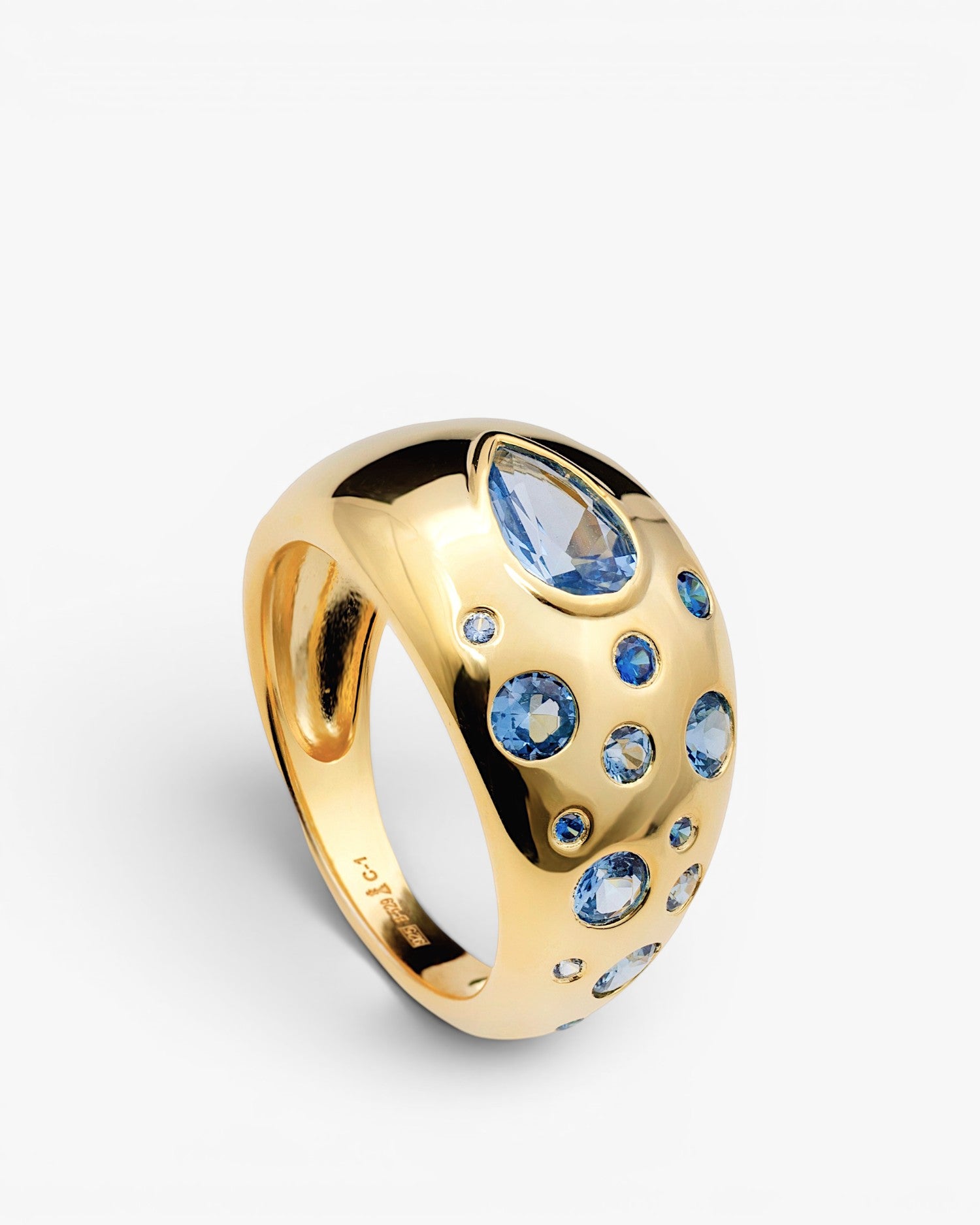 Anillo abombado de plata bañada en oro con piedras azules
