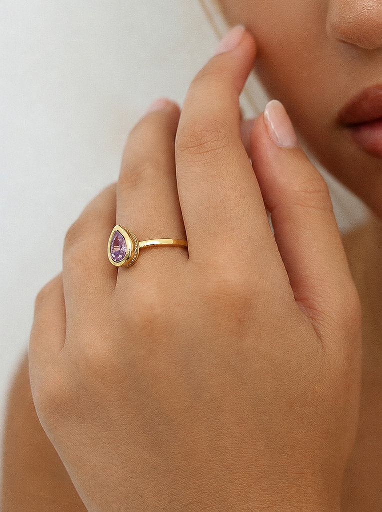 Small teardrop-shaped ring with a purple stone