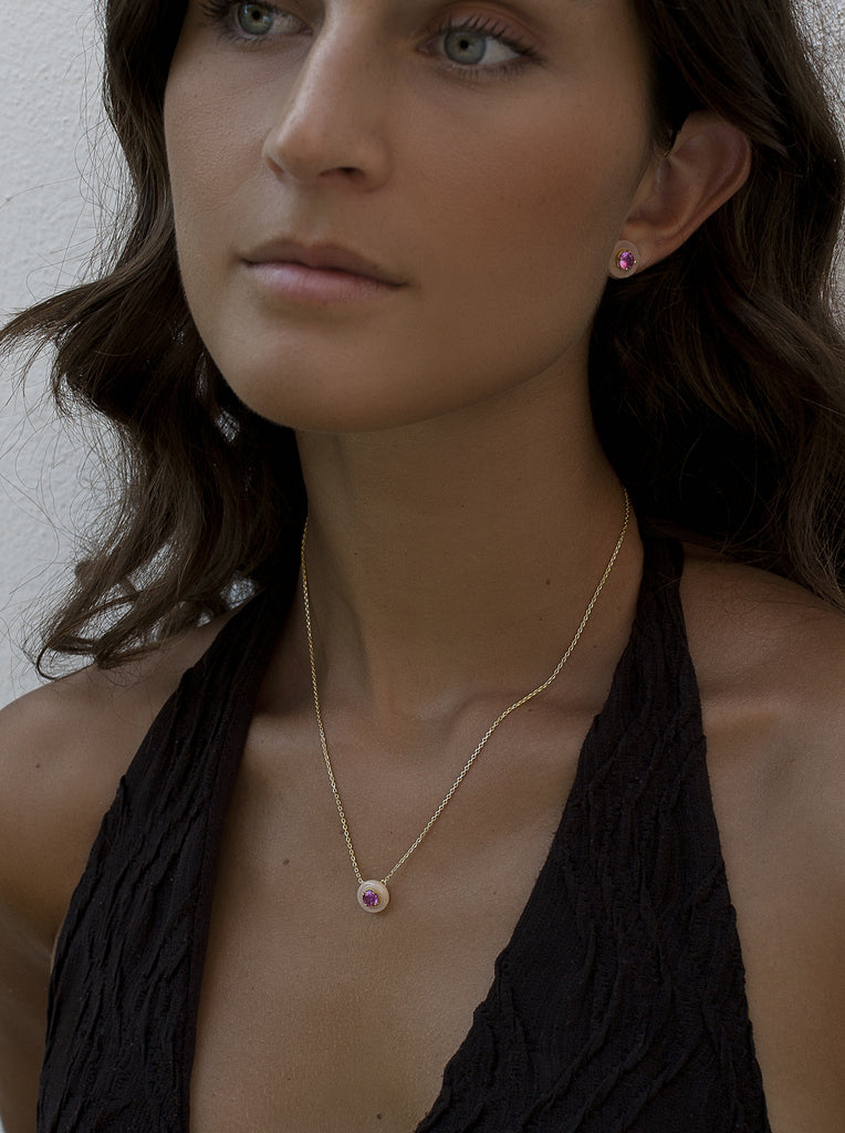 Gold necklace with pink disc pendant and fuchsia zirconia