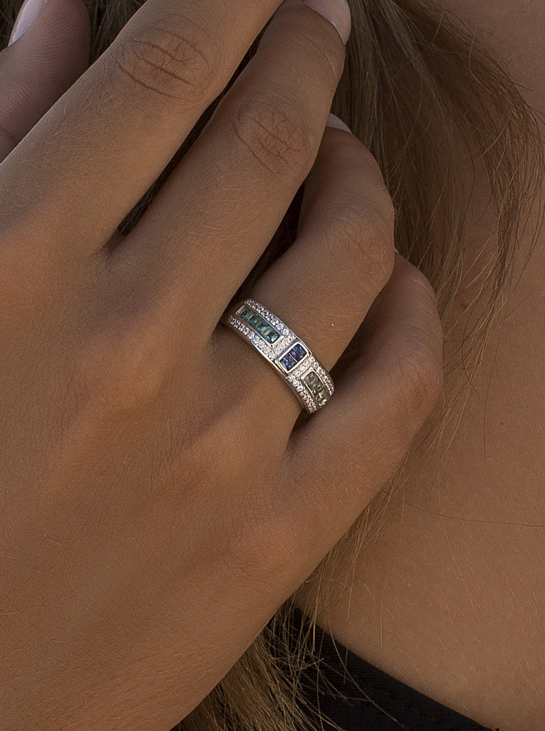 Silver ring with green, purple, and champagne stones