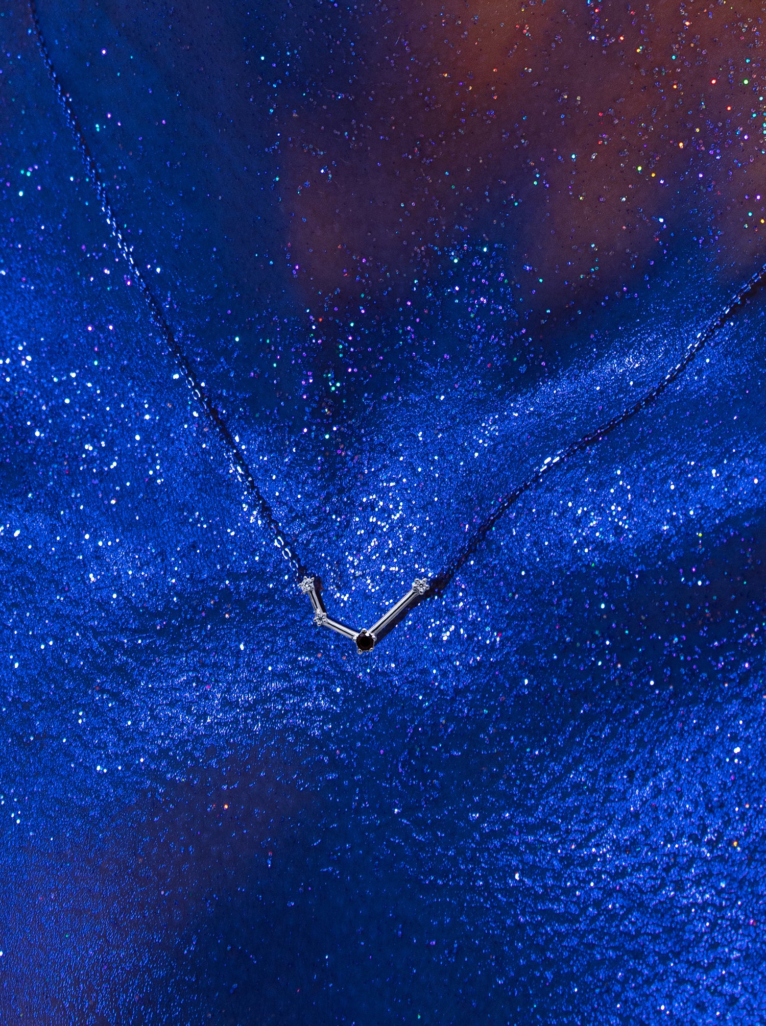 Aquarius Constellation pendant in silver with natural garnet.
