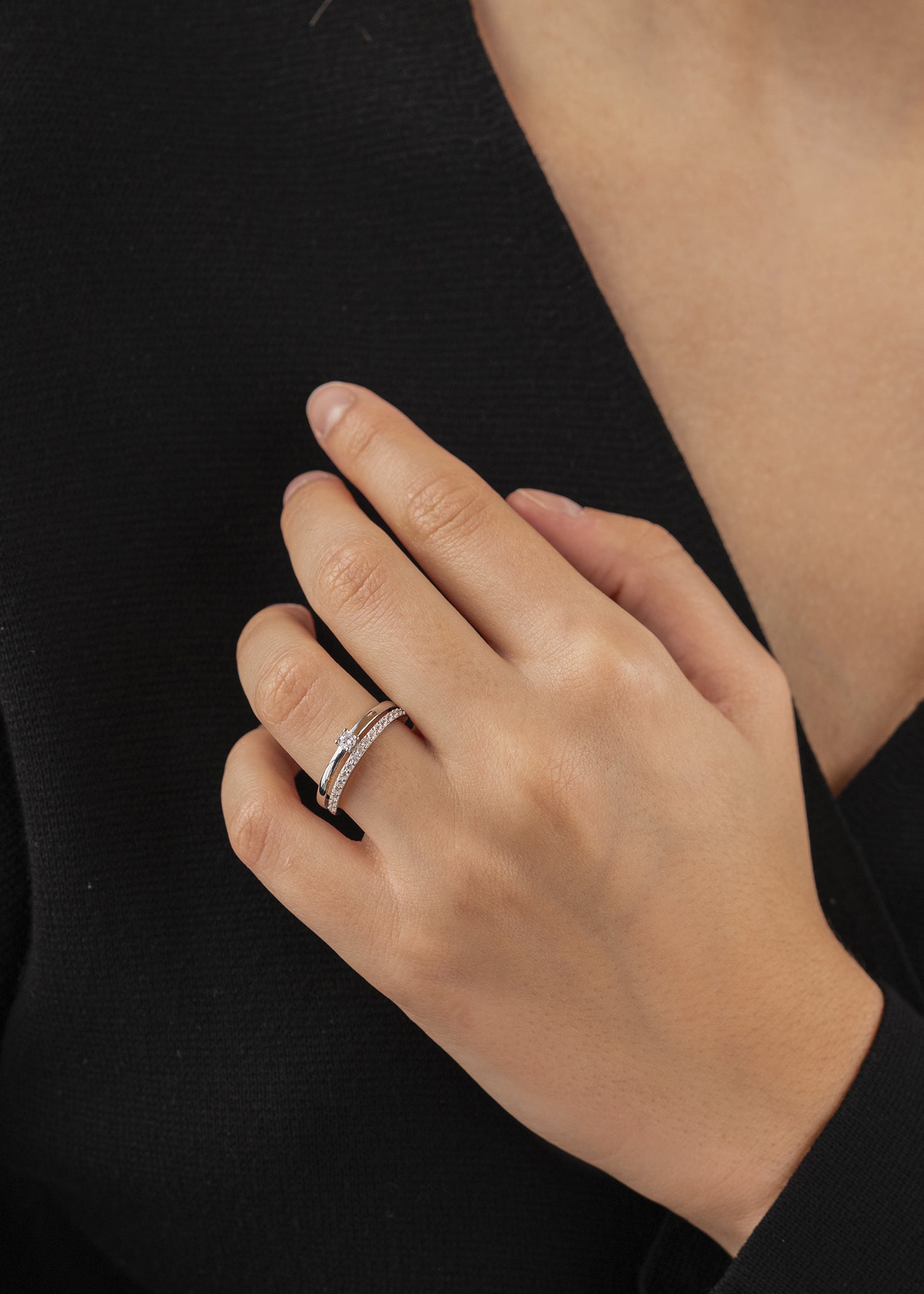 Delicate ring with double cubic zirconia and central cubic zirconia.