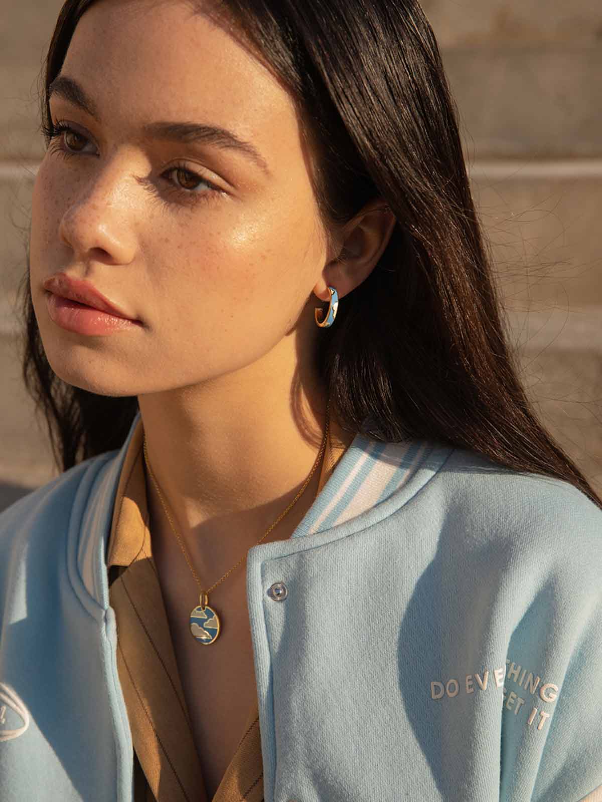 Silver medal necklace with electric blue enamel cloud motif
