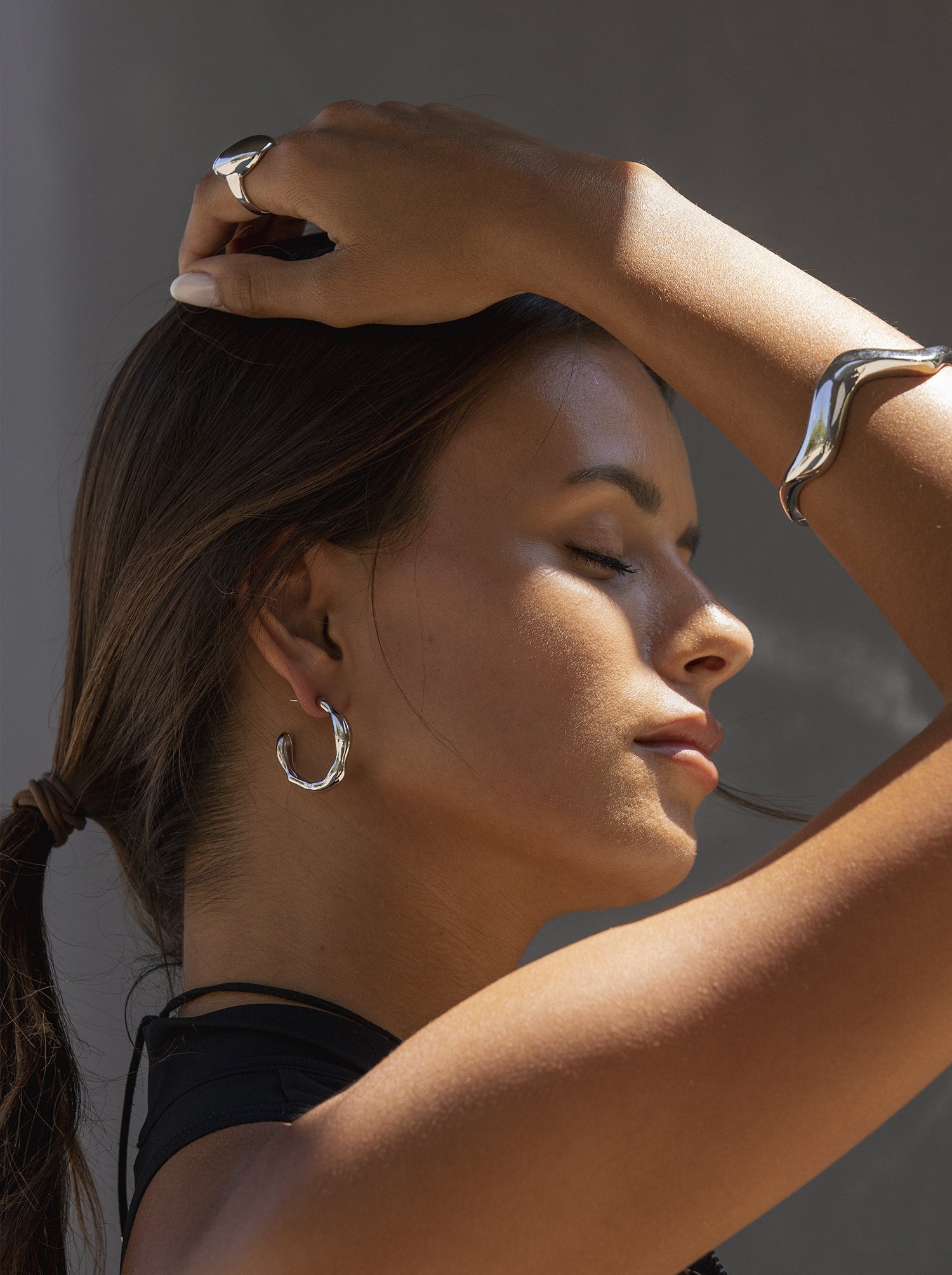 Hoop earrings with an irregular, liquid-style design