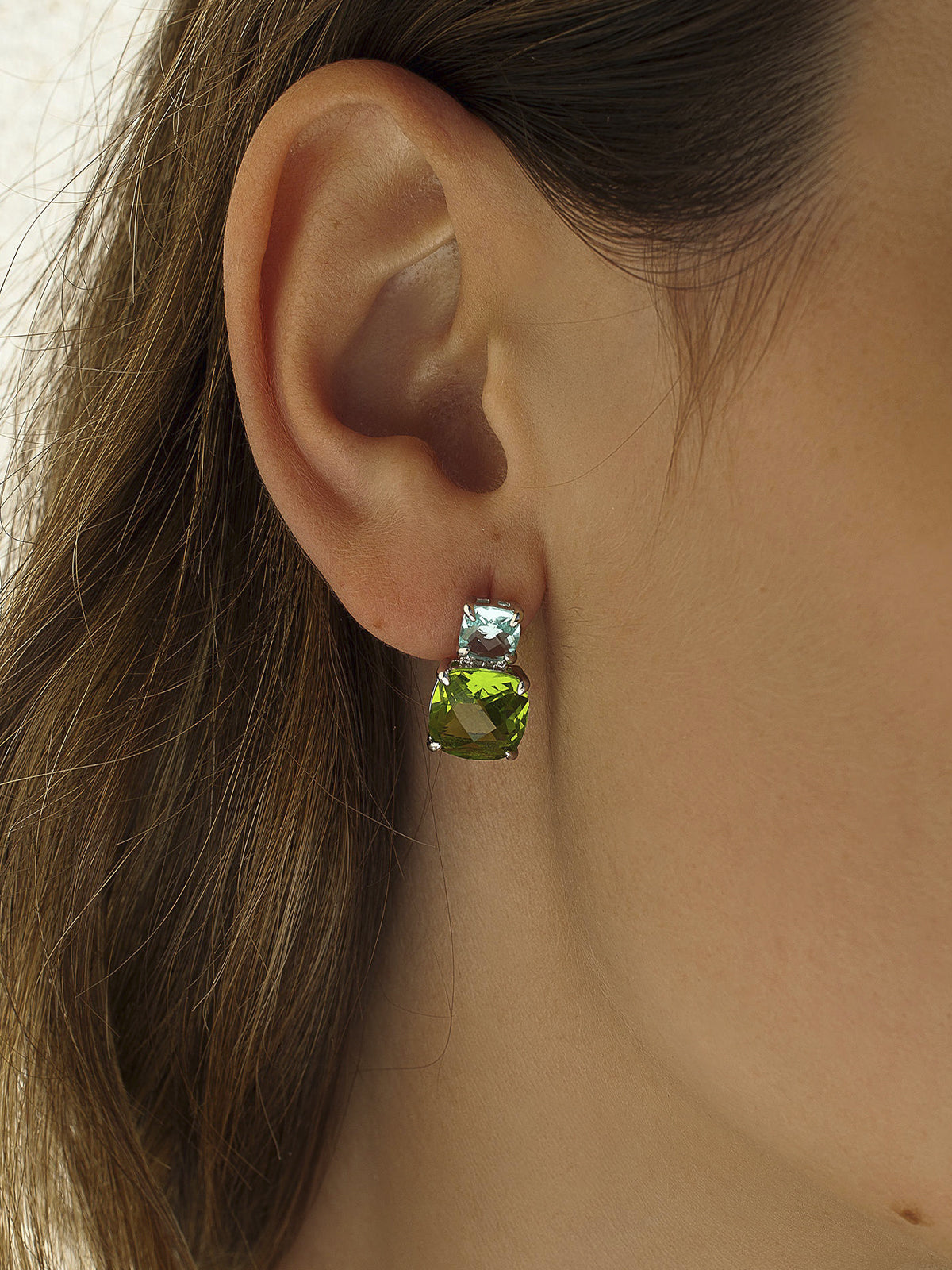 Colorful gemstone earrings with a two-tone gem design