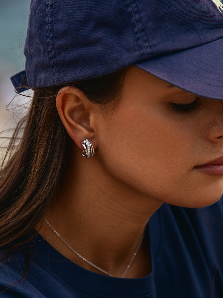 Omega clasp earrings with diagonal channel design and cubic zirconia
