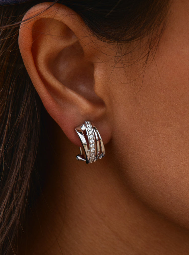 Omega clasp earrings with diagonal channel design and cubic zirconia