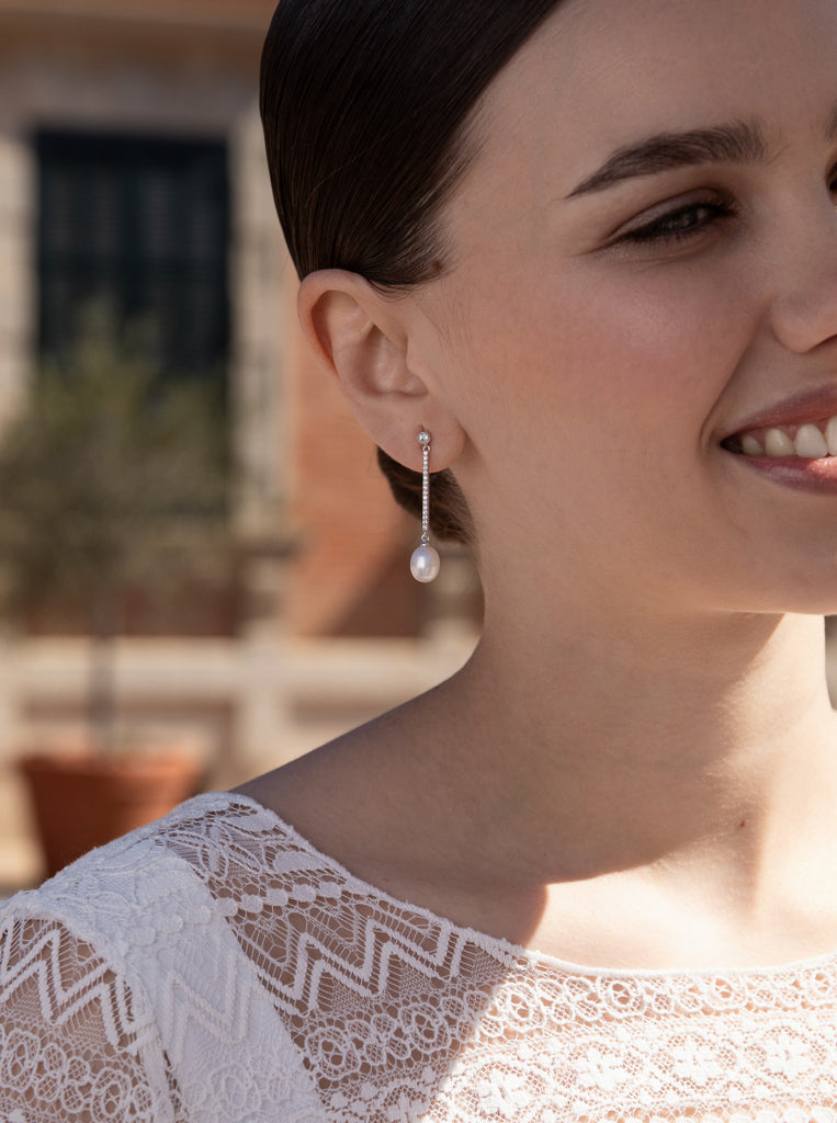 Long silver earrings with freshwater pearls that move and cubic zirconia detail