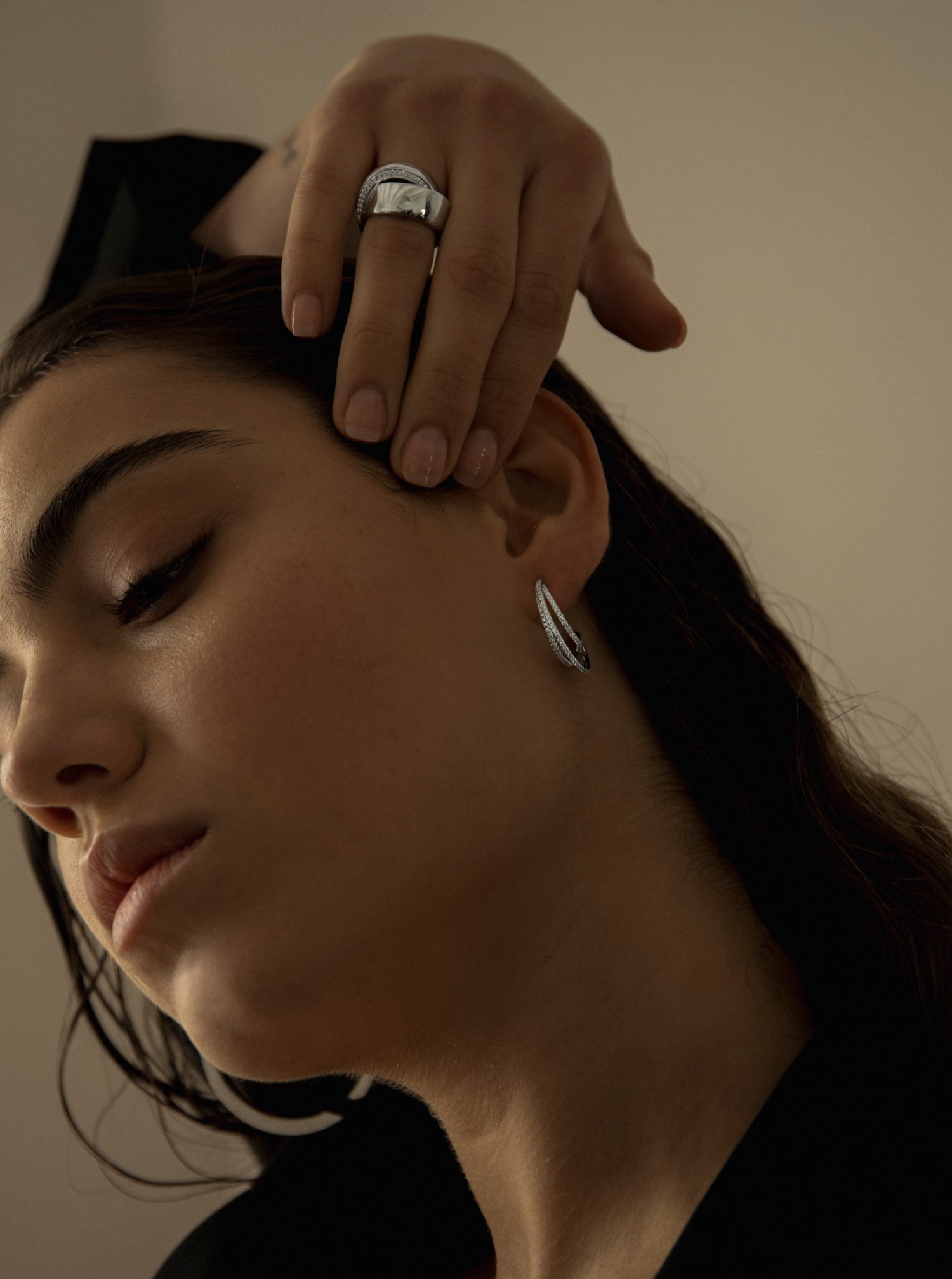 Large rings with an intertwined curvilinear design and cubic zirconia