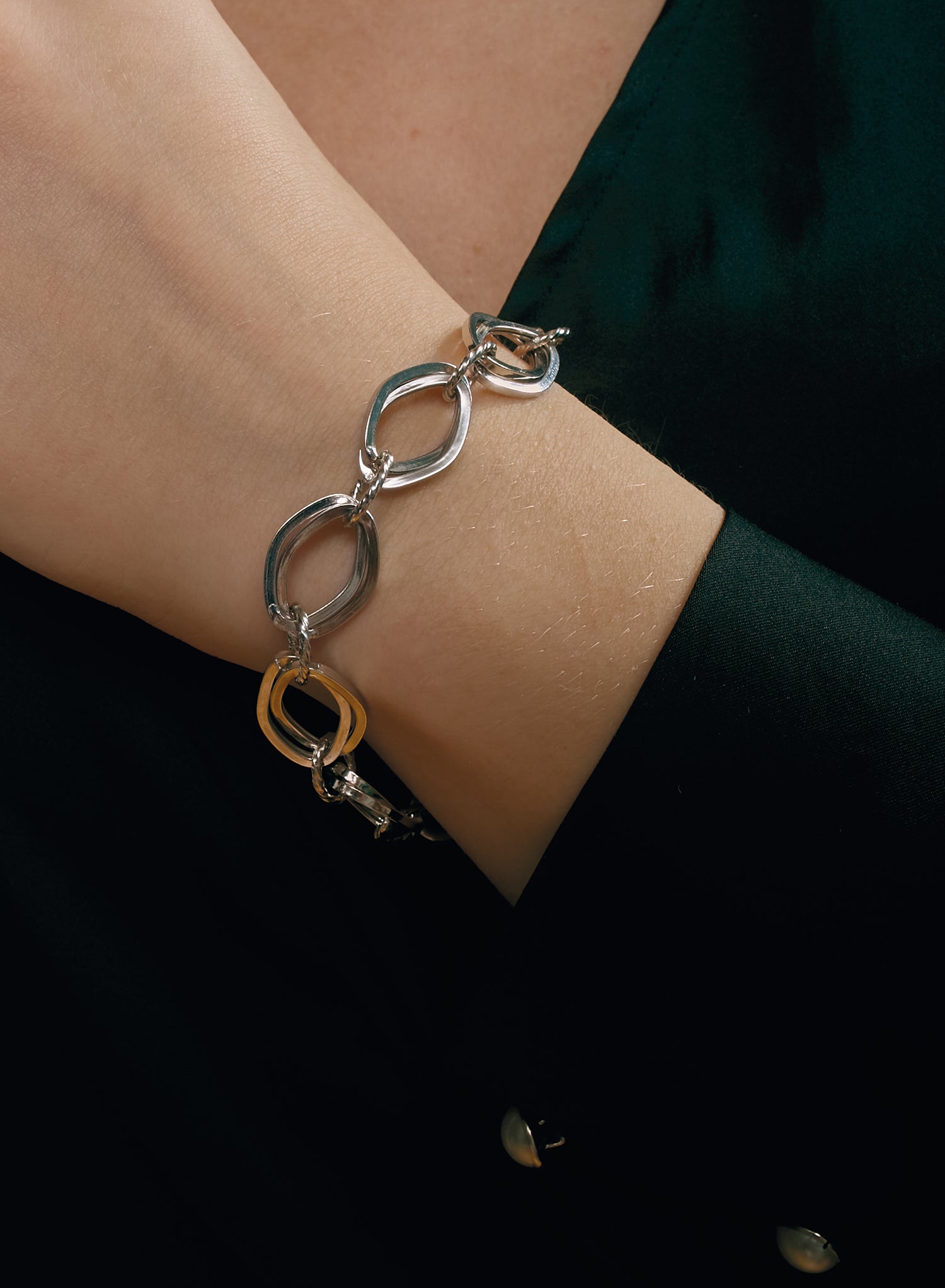 Silver link bracelet with curved ring design