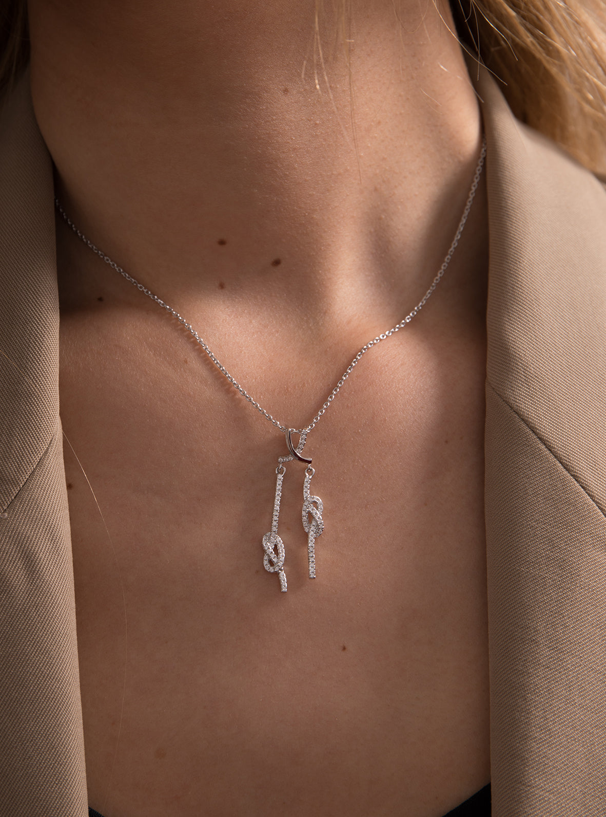 Original silver necklaces with double knot design and cubic zirconia.