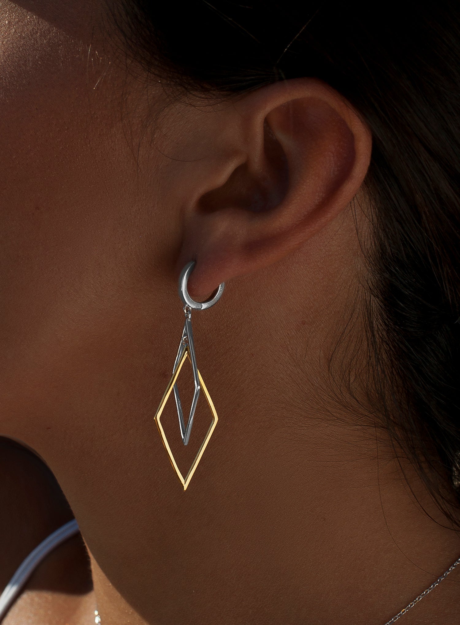 Long two-tone silver earrings with a diamond design