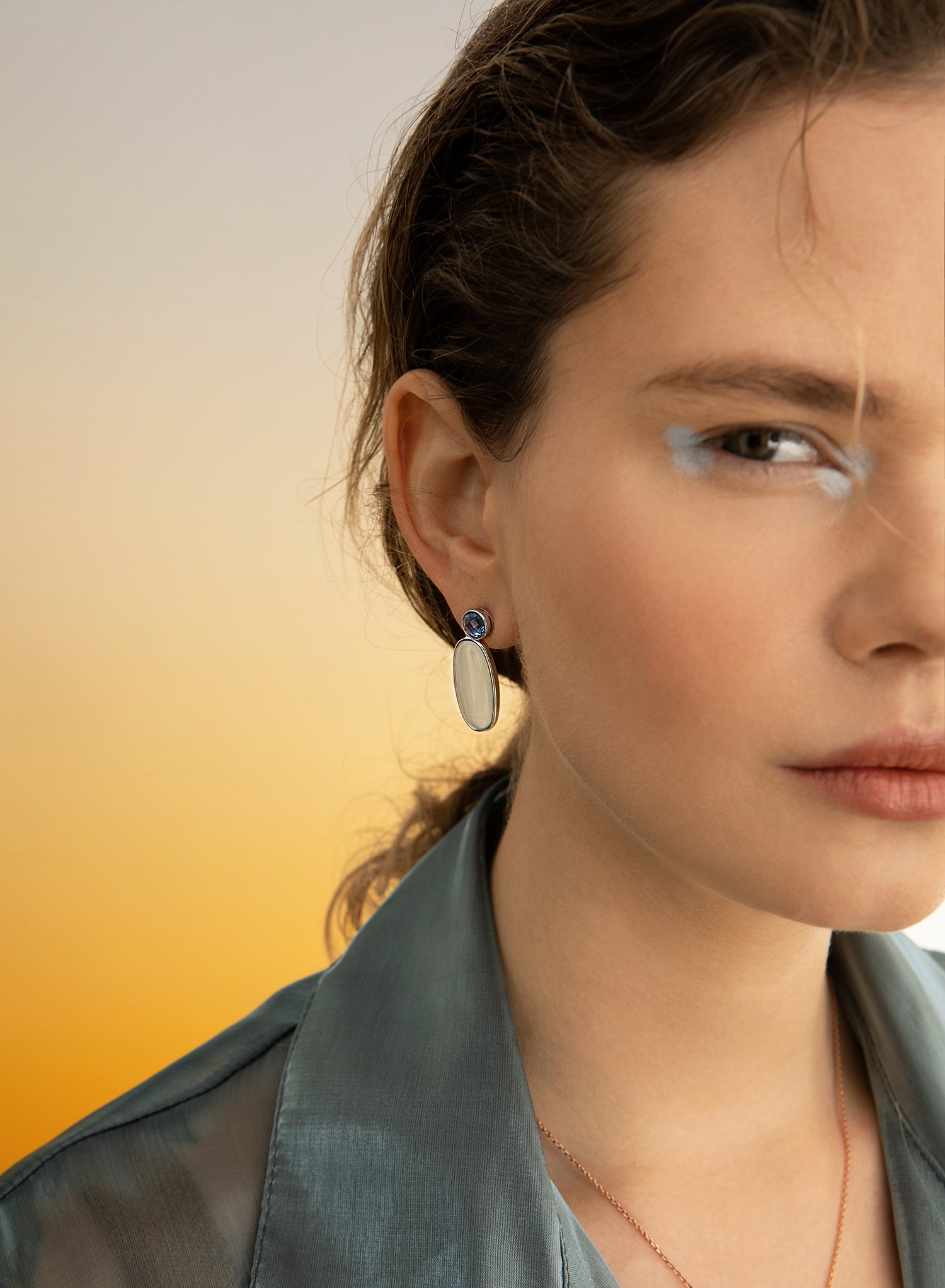 Silver-plated colored stone earrings with a long oval design in green