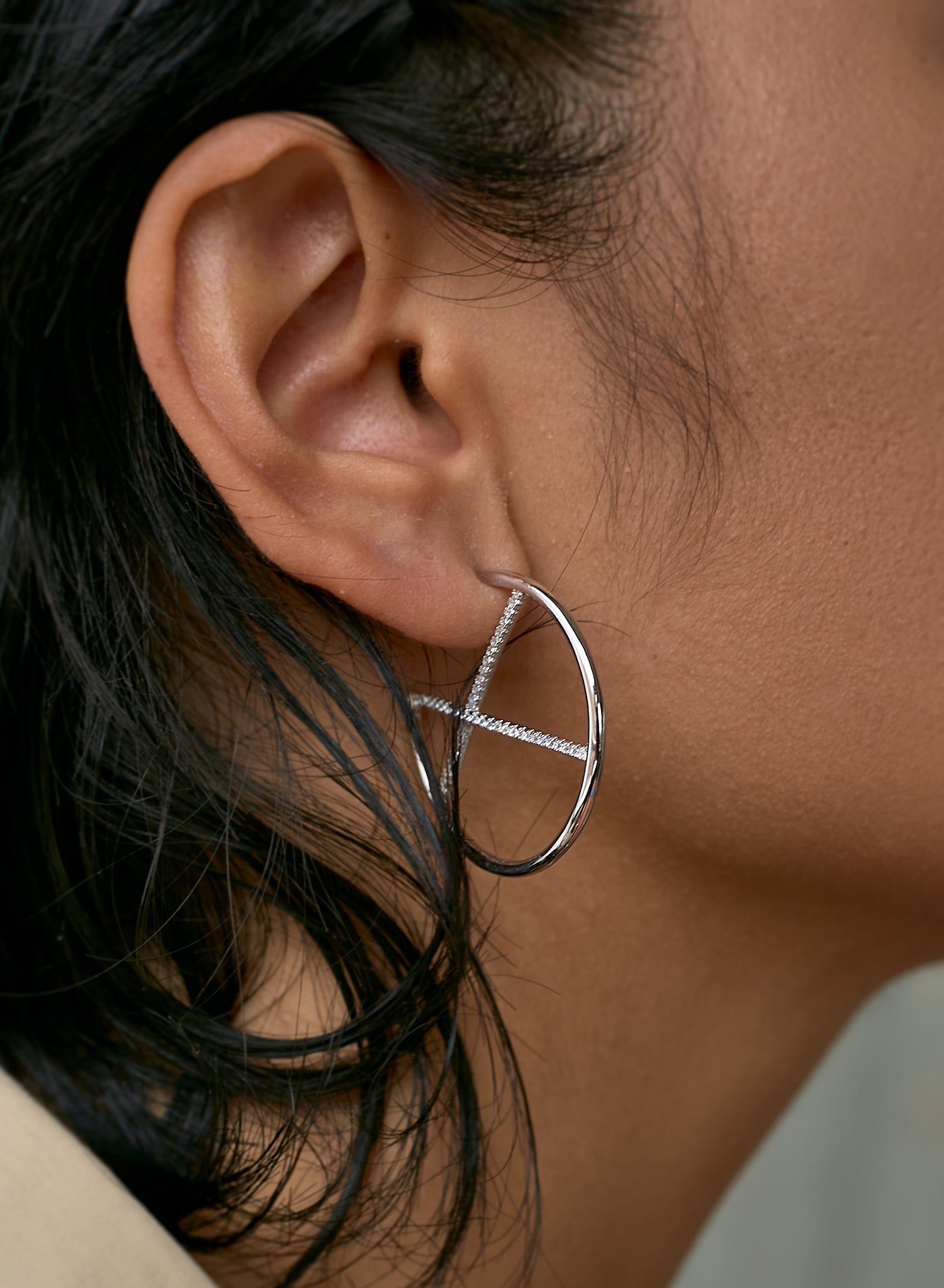 Original hoop earrings with crossed cubic zirconia channel design