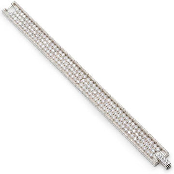 Pulsera riviere de plata con múltiples raíles de cuarzos adamantinos blancos redondos y detalle de circonitas en los lados