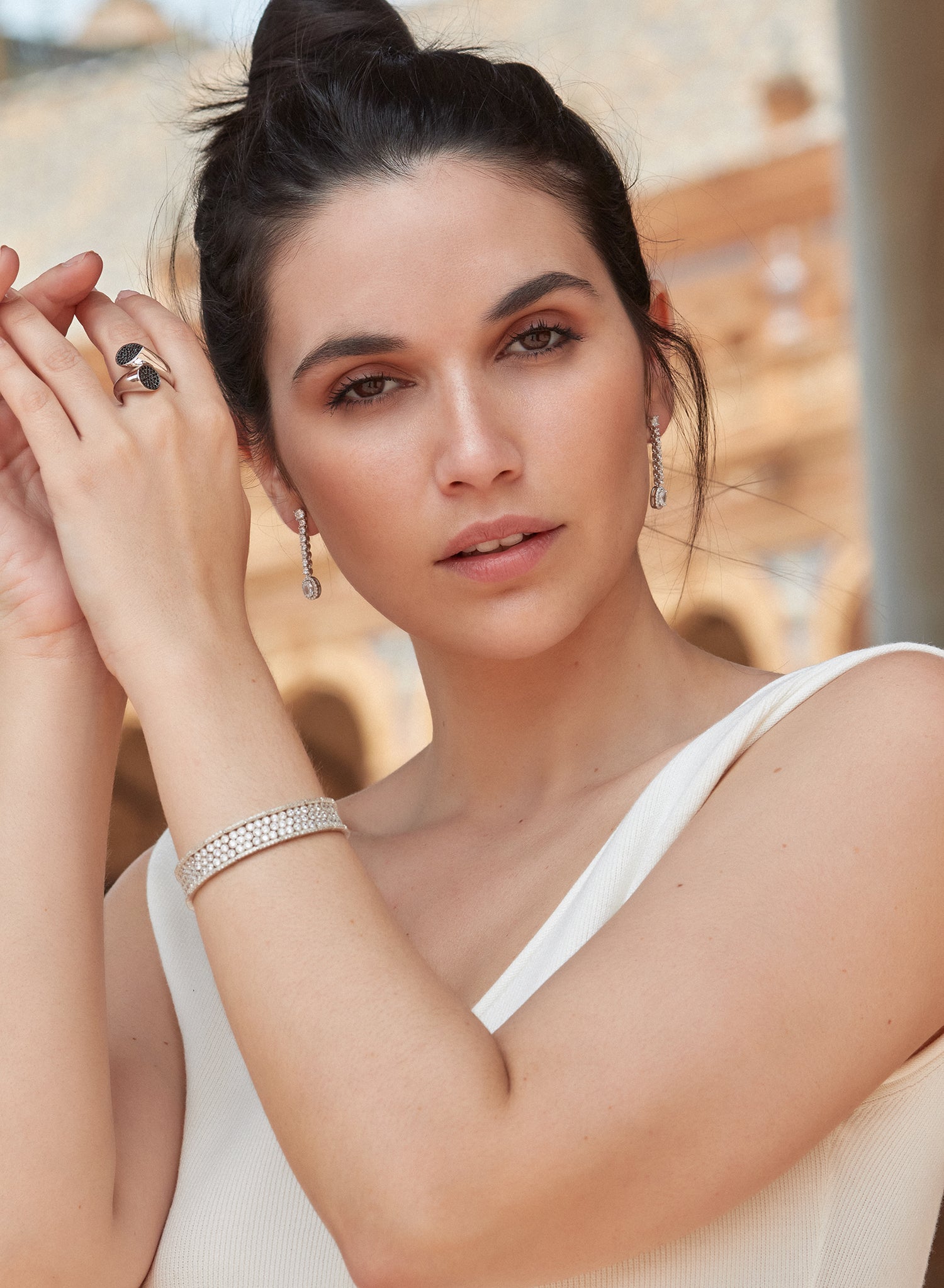 Silver riviere bracelet with multiple rails of round white adamantine quartz and cubic zirconia detail on the sides