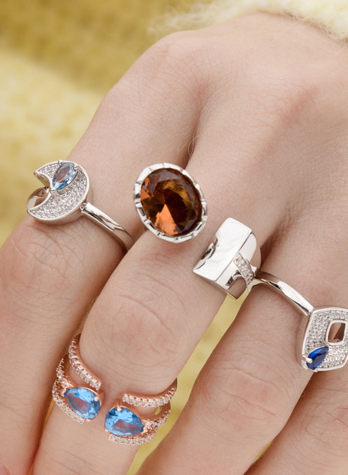 Large open design rings with bronze-tone stone